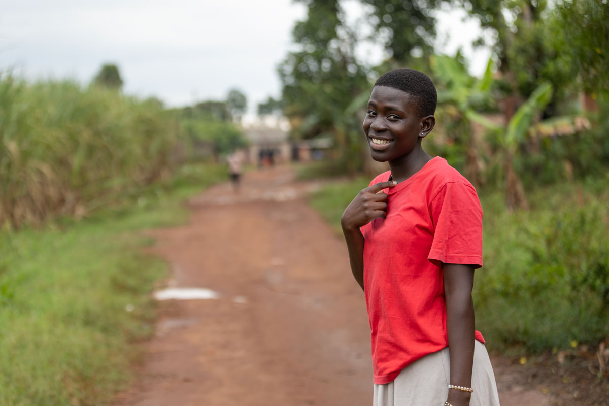 Annet, a teenager, smiles back at the camera.